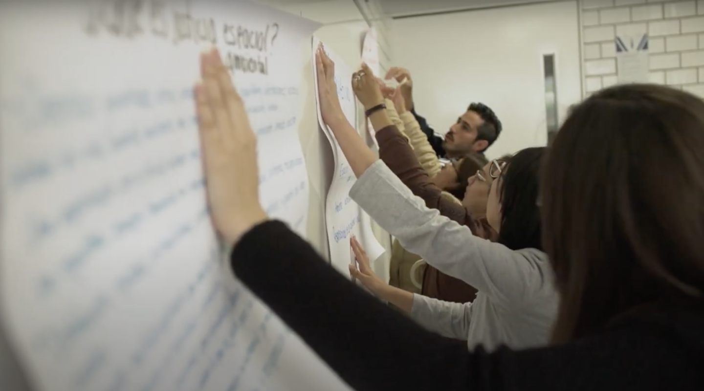 students working together to hand up posters for an event