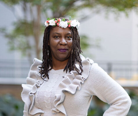 Woman wearing flowers in her hair, hand on hip