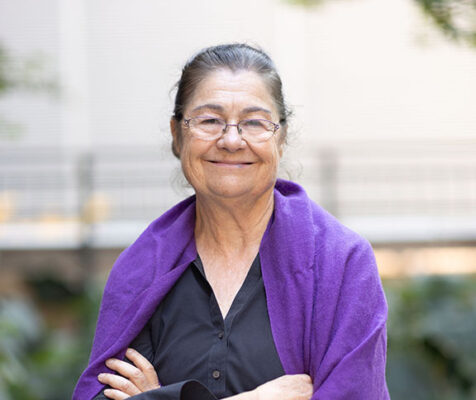 Woman with arms casually folded, smiling