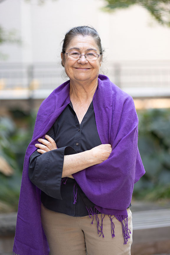Woman with arms casually folded, smiling