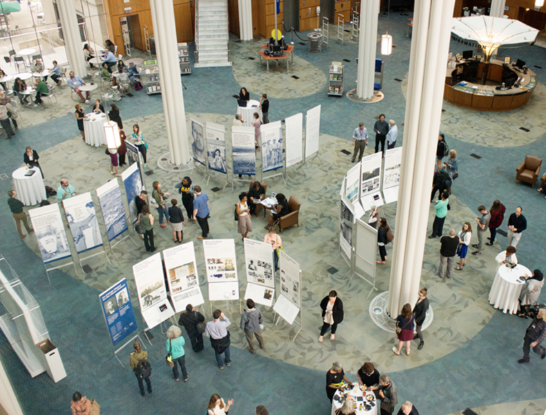 Large exhibit hall with some people milling about