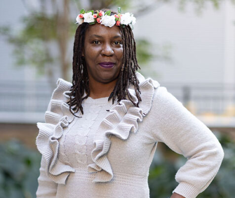 Woman wearing flowers in her hair, hand on hip