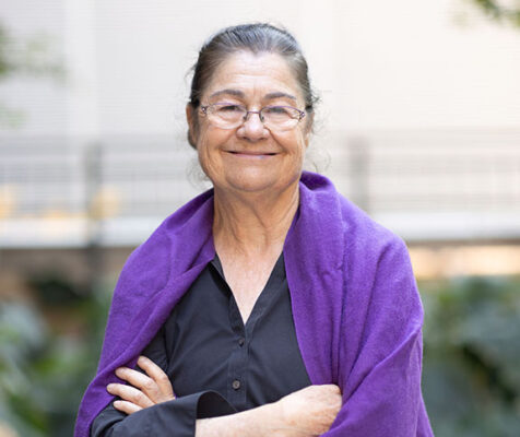 Woman with arms casually folded, smiling