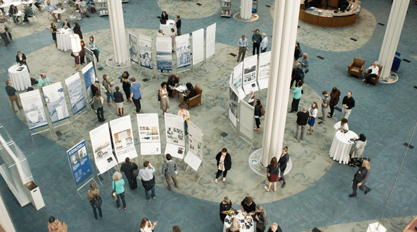Large exhibit hall with some people milling about
